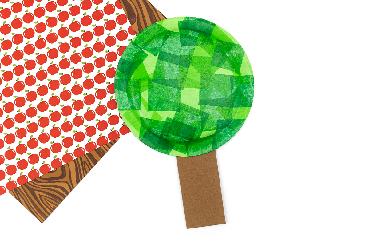 Cardboard tree trunk and paper plate leaves.