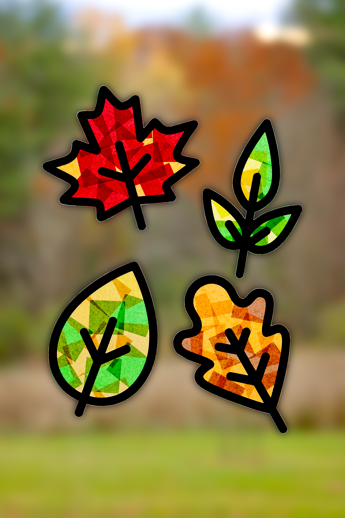 Finished fall leaf suncatchers hanging on a window.