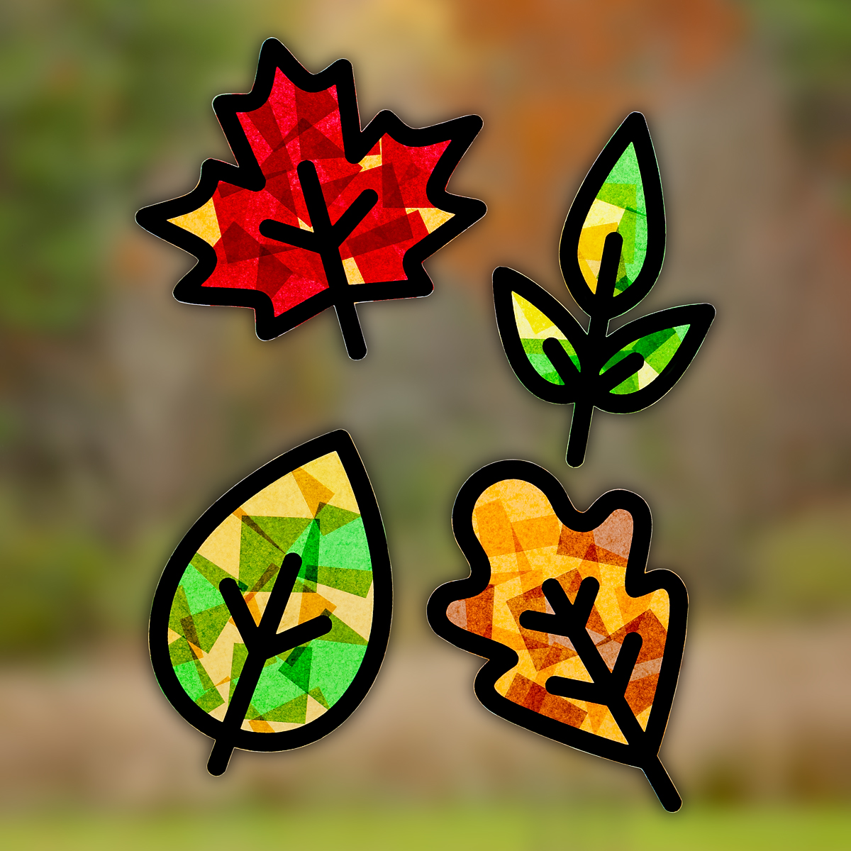 Four fall leaf suncatchers hanging on a window.