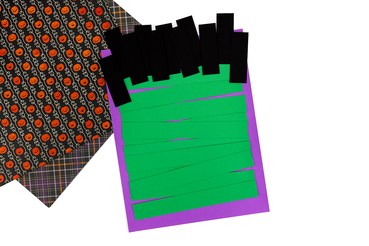 Green paper strip Frankenstein craft with black hair.