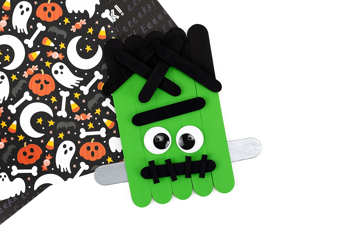 Lime green Frankenstein popsicle stick craft for kids.