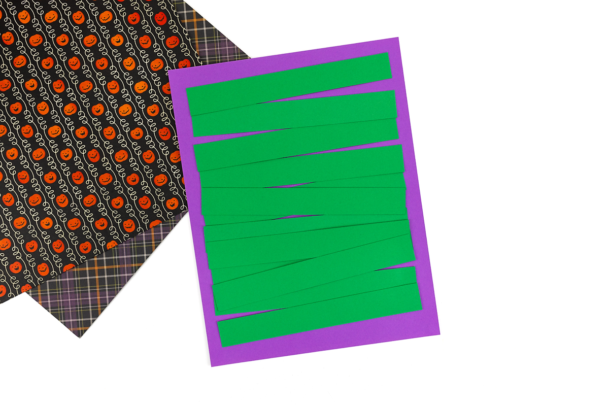 Green paper strips on purple paper.