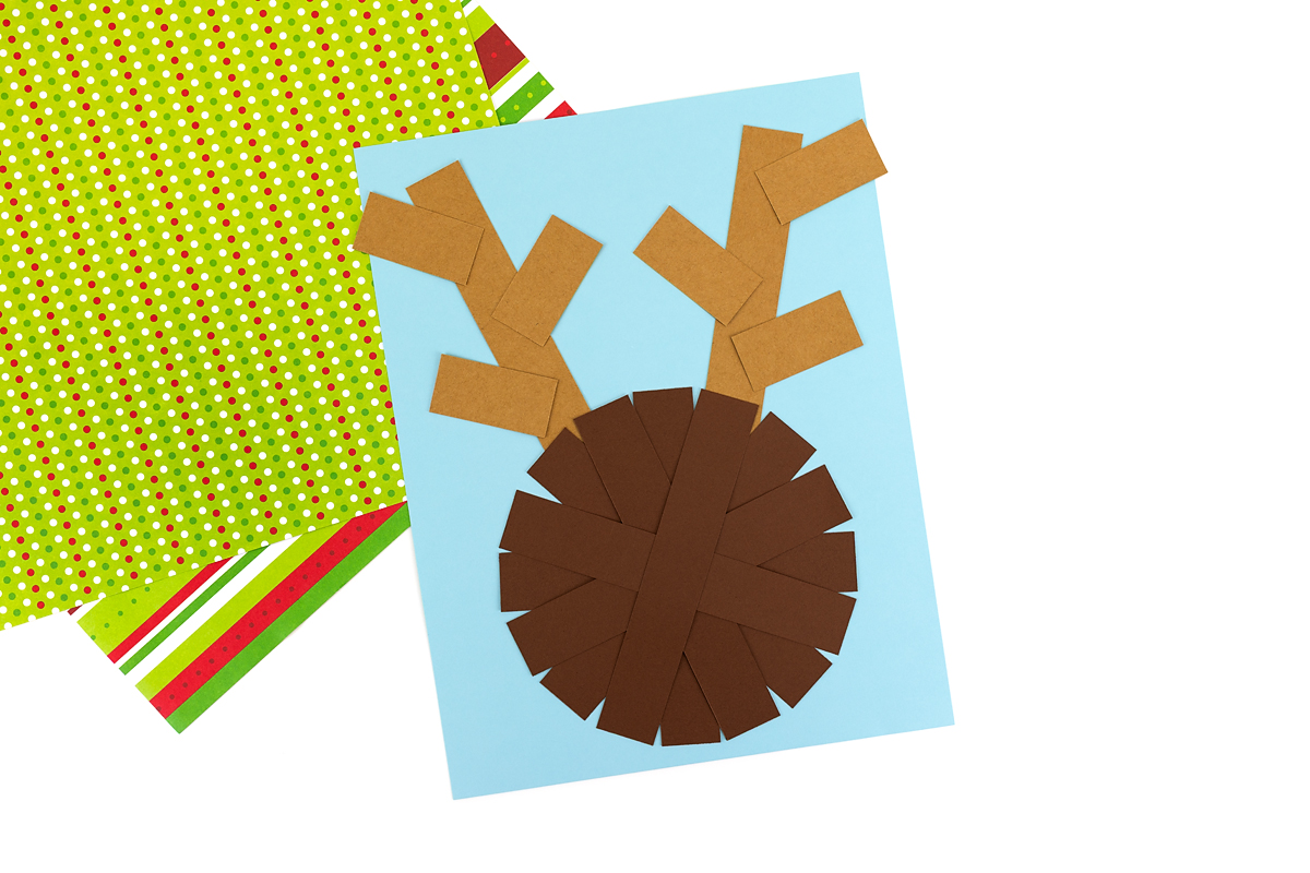 Gluing six short light brown strips onto the antlers to form the antler points.