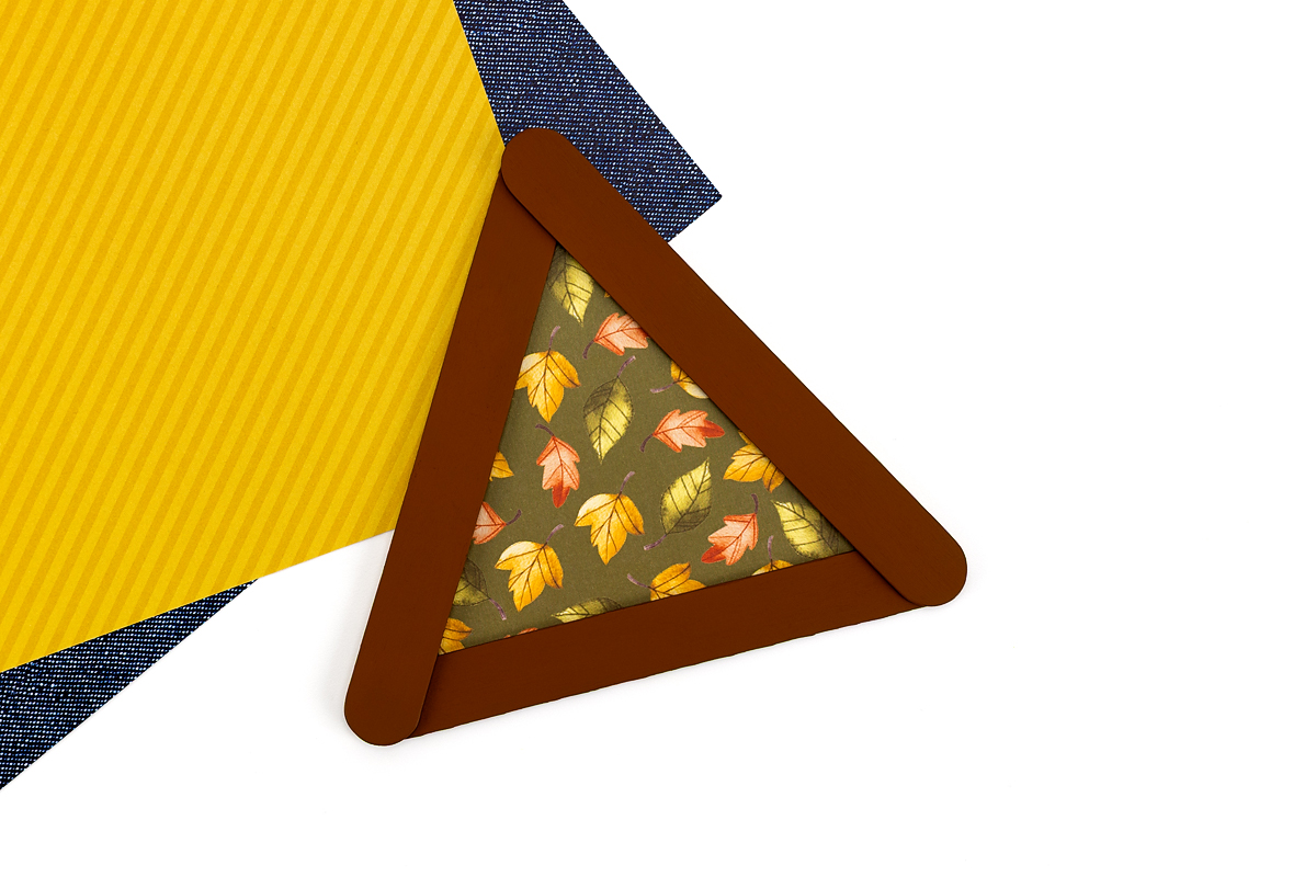 Popsicle stick turkey base with green paper.