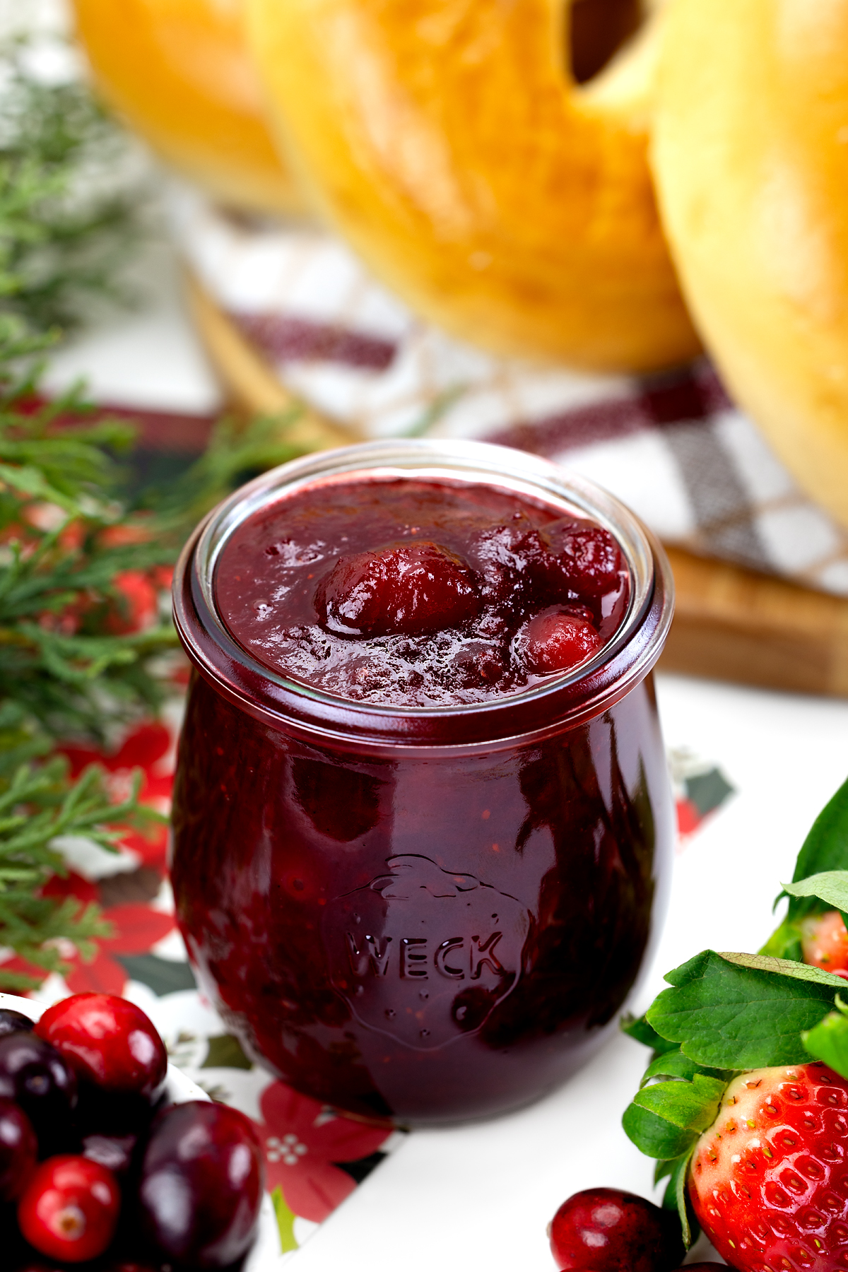A single jar of homemade Christmas Jam made with strawberries, cranberries, and orange, ready to enjoy or give as a gift.