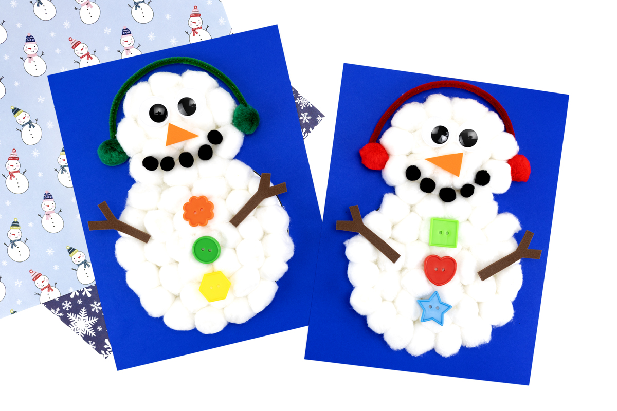 Two cotton ball snowmen displayed on a table, each decorated with buttons, wiggly eyes, and pipe cleaner earmuffs.