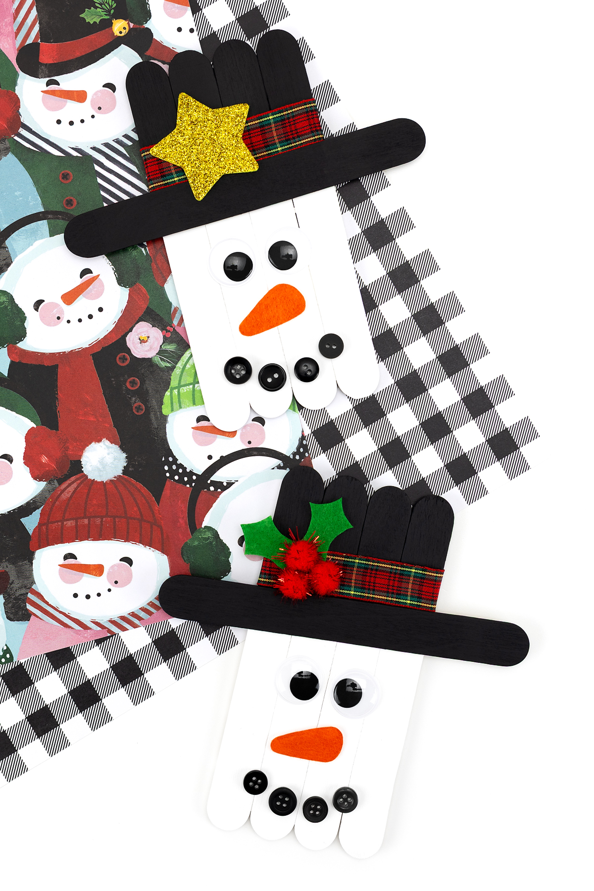 Two finished Popsicle Stick Snowmen ready for display.