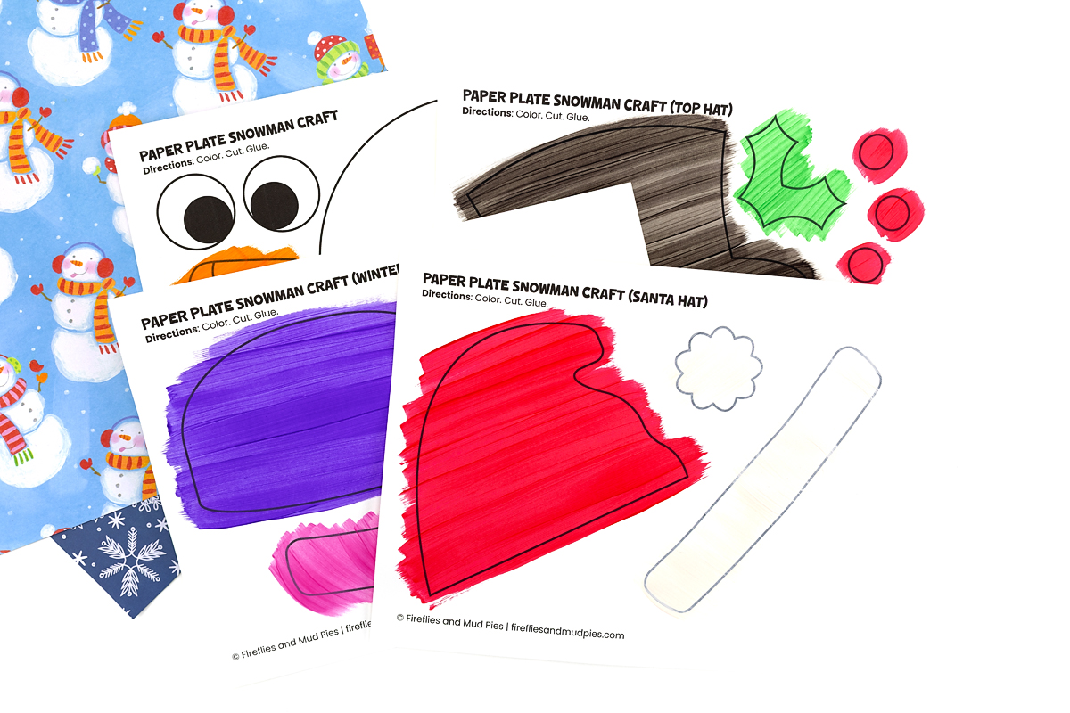 Snowman hat and carrot nose templates painted in bright colors and drying.