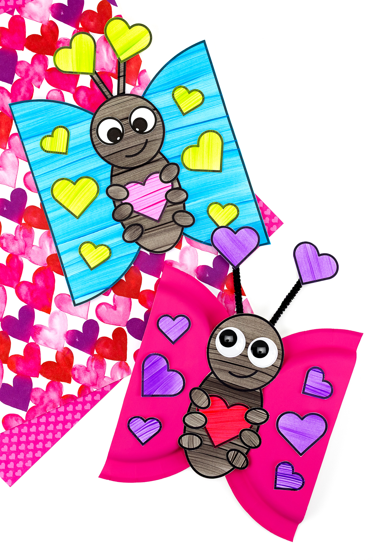 Two finished love bug crafts on a table. 