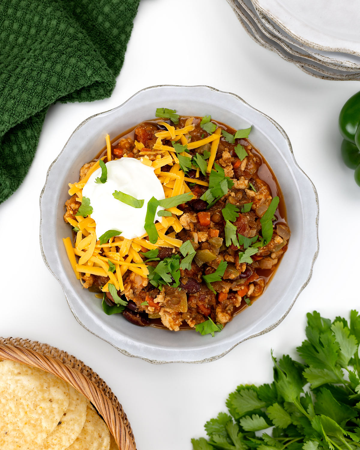 Turkey lentil chili topped with cheddar cheese, Greek yogurt, cilantro, and served with corn chips.