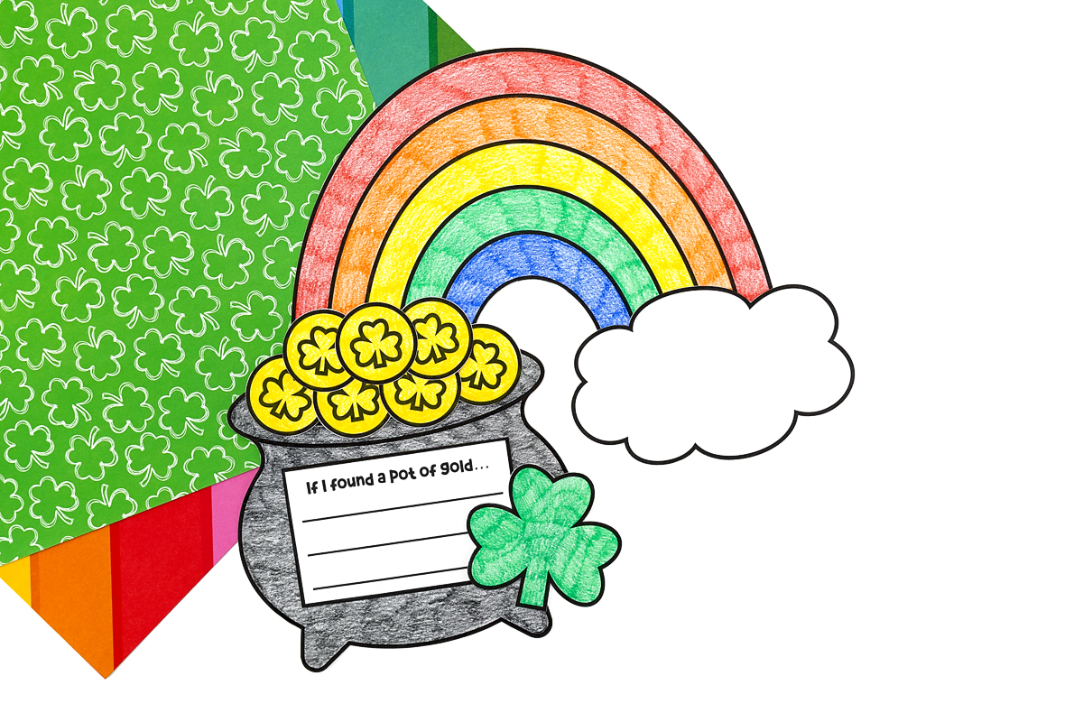 Gluing gold coins, shamrock, and writing prompt text box onto Pot of Gold Craft.