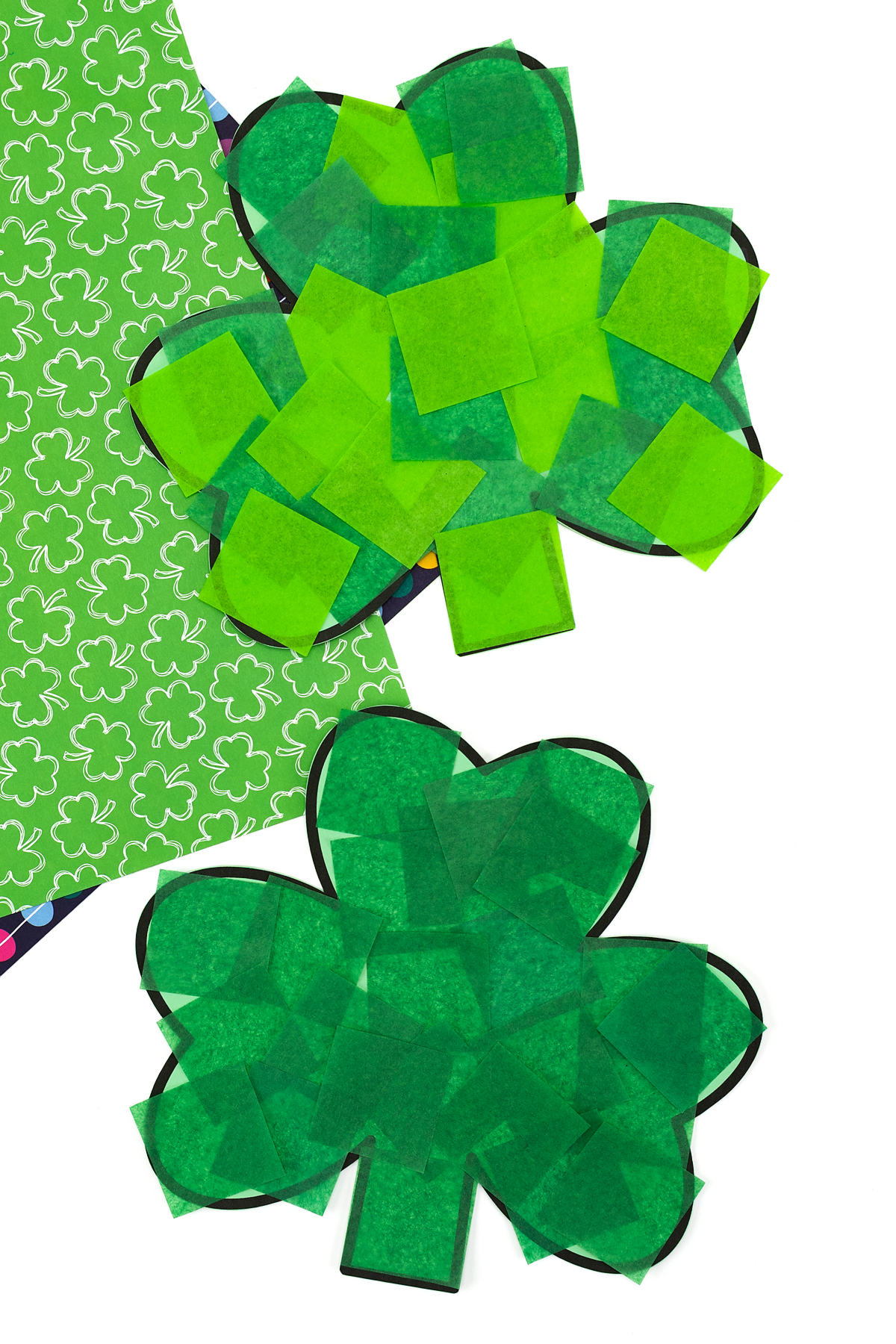 Textured shamrock craft with layered tissue paper pieces, perfect for a St. Patrick’s Day classroom activity.