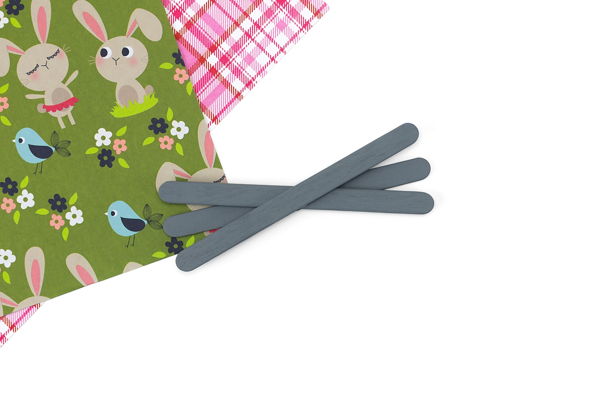 Three gray popsicle sticks arranged and glued together to create bunny whiskers.