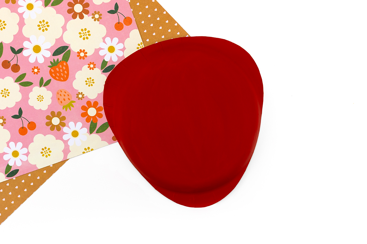 Paper plate strawberry painted red with smooth, even coverage.