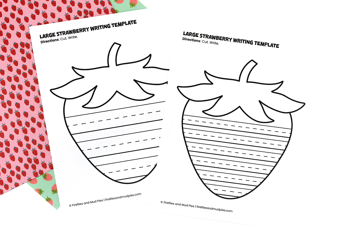 Large strawberry writing template printable with ruled lines inside the strawberry shape for early elementary writing activities.