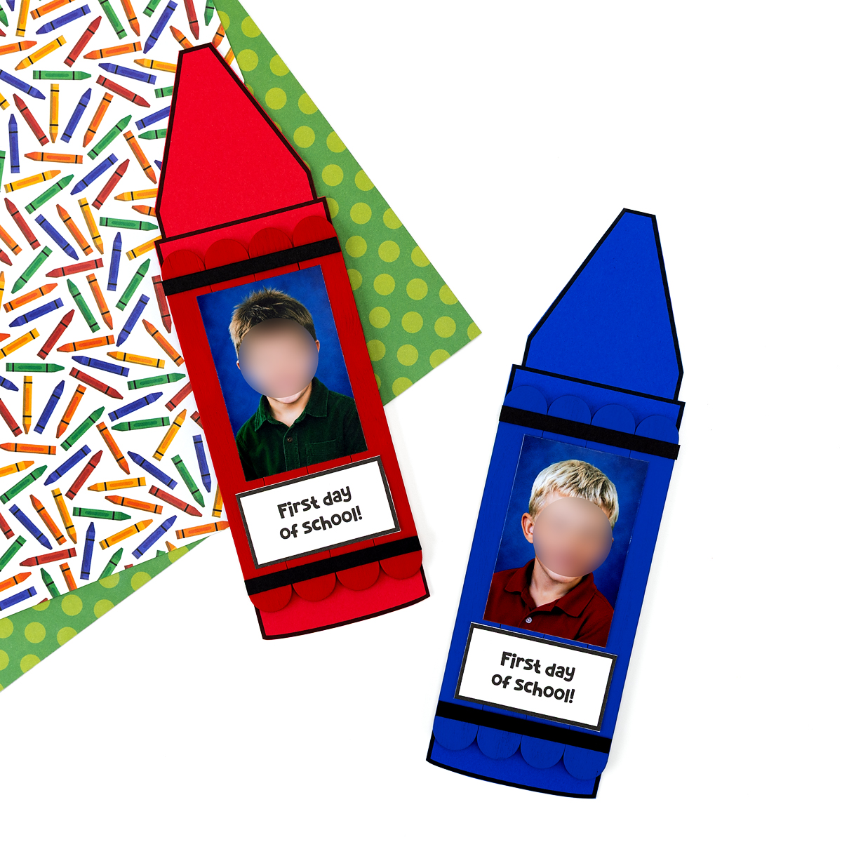 Finished red and blue popsicle stick crayon crafts with school photos and "First Day of School" labels, displayed on a crayon-print background.
