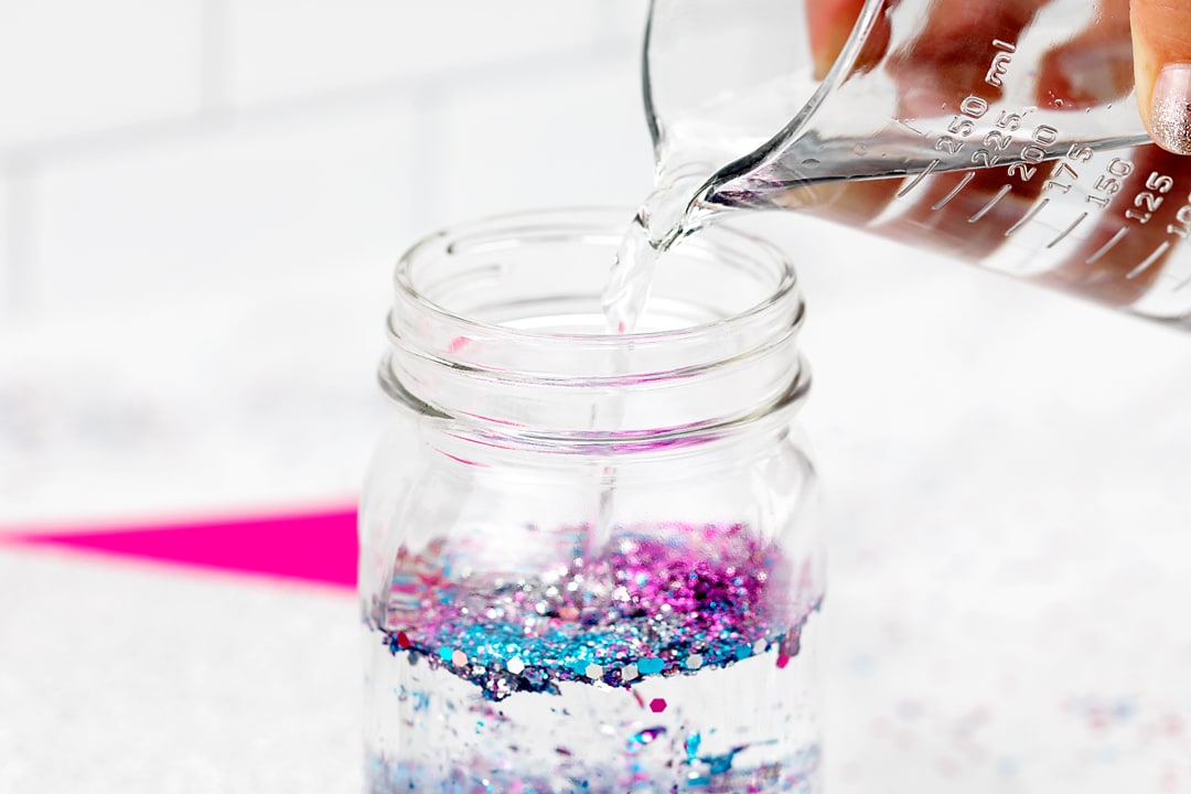 Pouring Water Into a Glitter Jar