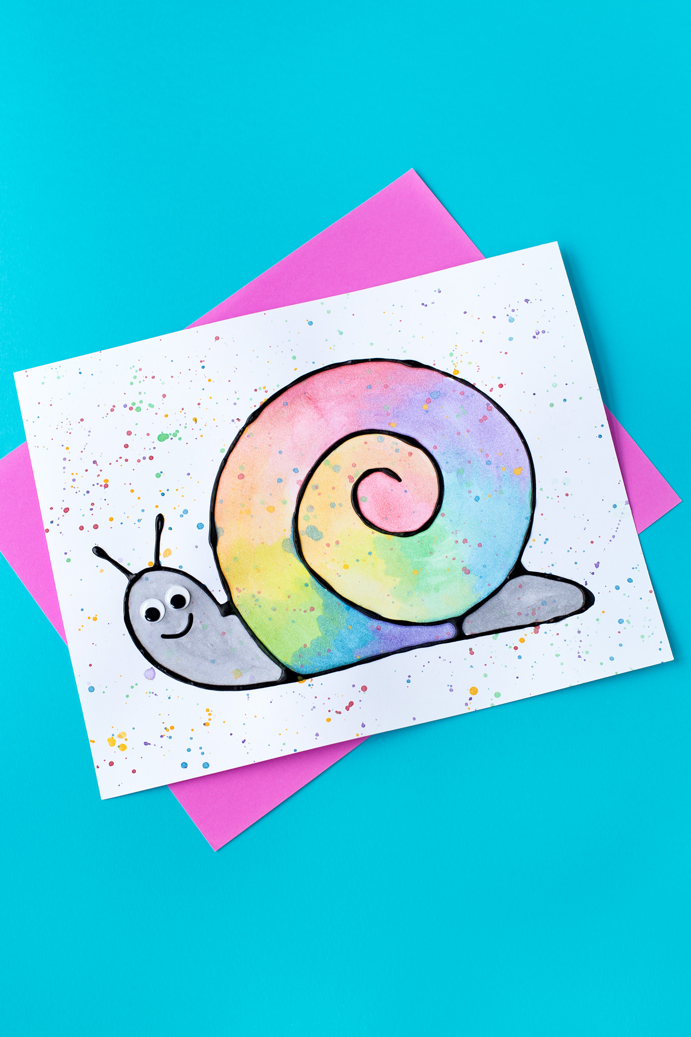 Learn how to make Black Glue and Watercolor Snail Art. This art activity for kids includes a free template, making it perfect for home or school.