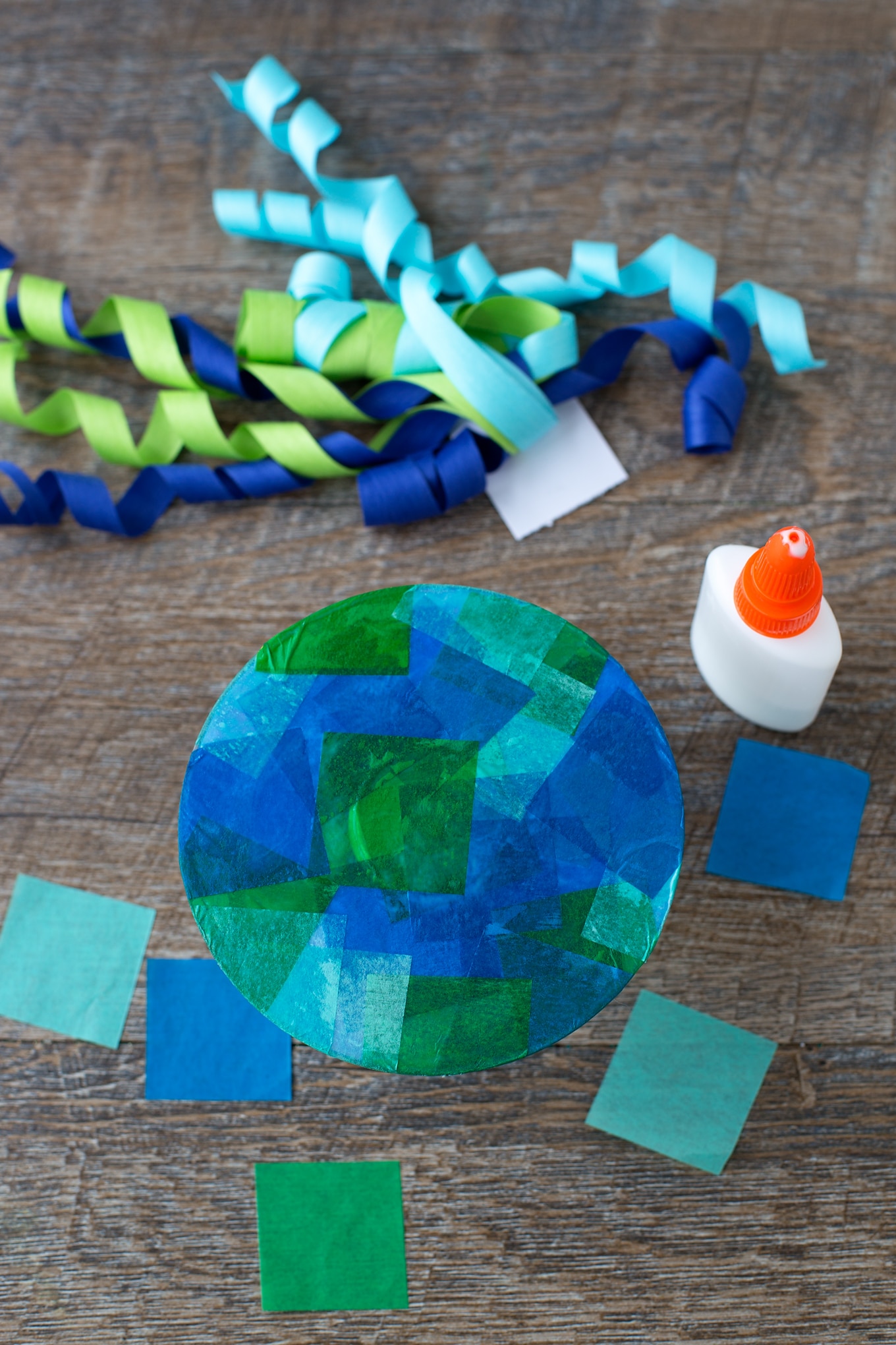 Summer is the perfect season for creating ocean-themed art. Learn how to make a colorful upcycled CD and ribbon jellyfish craft. #jellyfishcrafts #summercrafts #oceancrafts #animalcrafts #kidscrafts Tissue Paper Jellyfish Craft In-Process