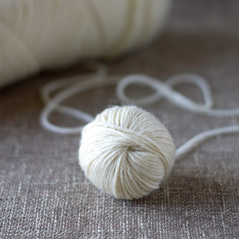 Discover money saving natural laundry tips and tricks and learn how to make wool dryer balls to soften clothes and speed drying time, naturally.