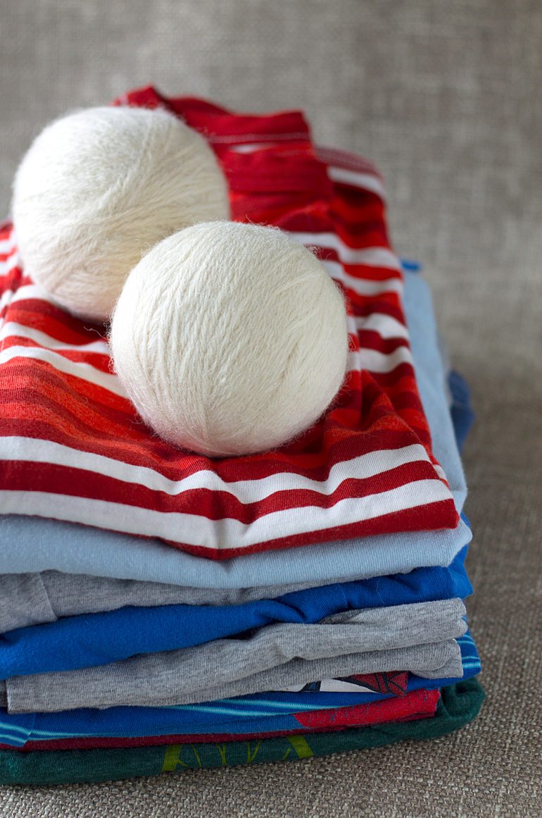 Discover money saving natural laundry tips and tricks and learn how to make wool dryer balls to soften clothes and speed drying time, naturally.