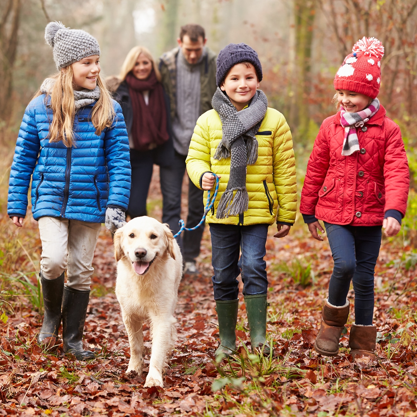 Happy Family Enjoying a Nature Walk with Dog Happy Family Enjoying a Nature Walk with Dog
