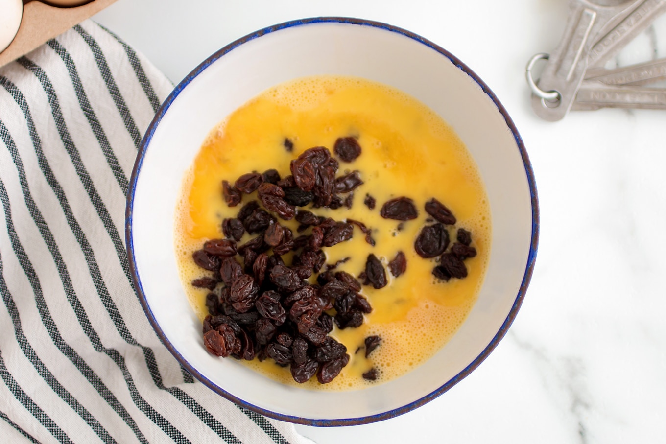 Raisins Soaking in Vanilla and Fresh Eggs Raisins Soaking in Vanilla and Fresh Eggs