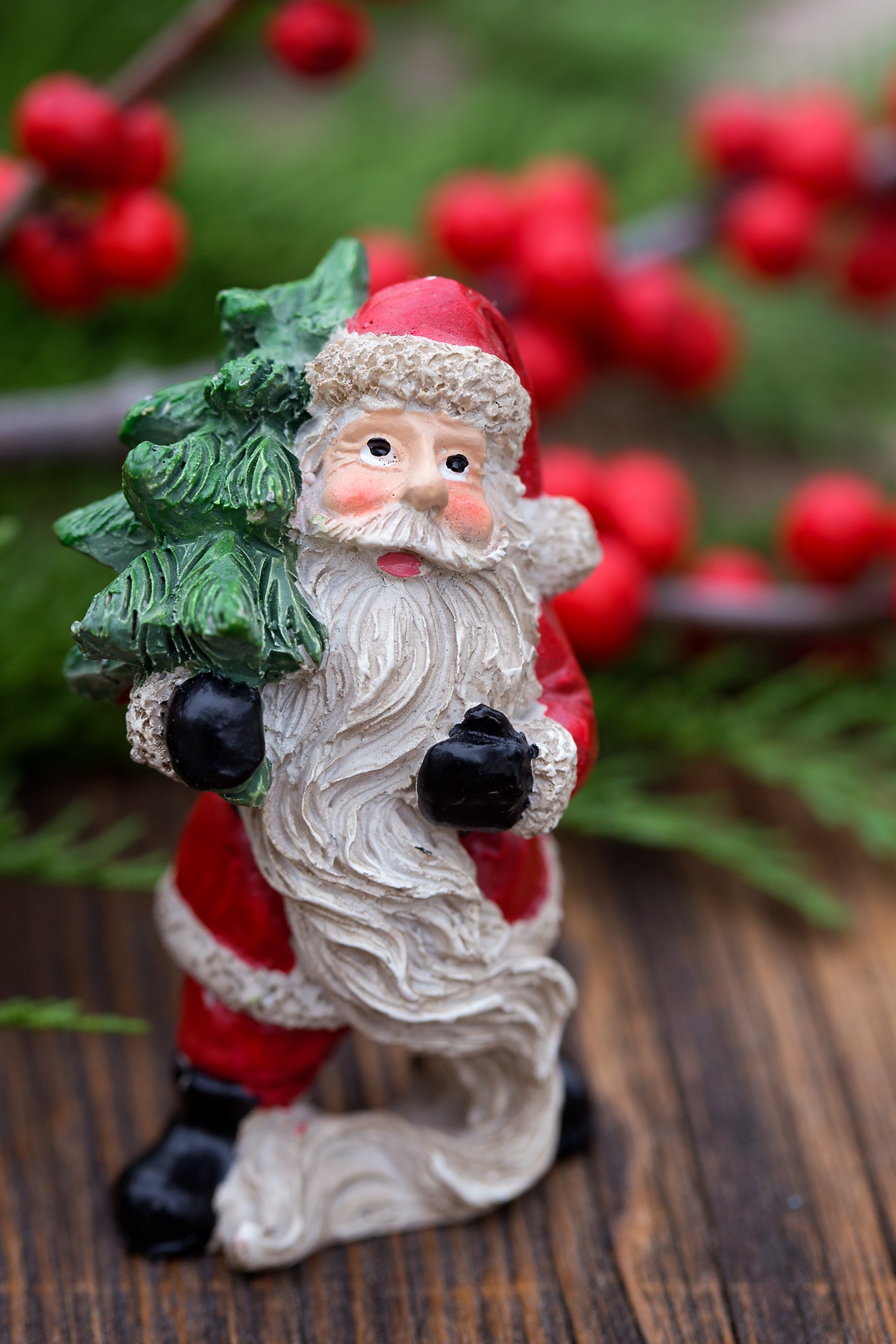Just in time for Christmas, learn how to make a festive Christmas Teacup Garden with pine sprigs, winterberry, a teacup and saucer, and Christmas miniatures. #diychristmasgift #christmascrafts #teacupgarden #fairygardencrafts #christmasteacupgarden Santa Mini Figure for Christmas Teacup Garden