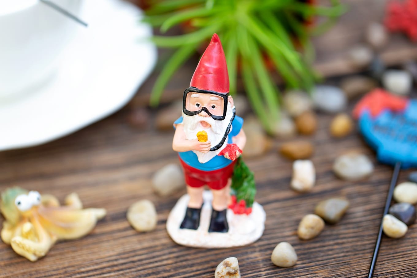 Summer is the perfect season for teacup fairy gardens! Whether kids are learning about the ocean, summer, gardening, or simply enjoying a creative nature activity at home, this easy and fun Under the Sea Teacup Garden is simply perfect for imaginative play. #teacupfairygarden #teacupfairygardenideas #howtomakeateacupfairygarden #summercraftideas #fairygarden #fairygardening #fairygardenkids Scuba Diving Gnome in Under the Sea Teacup Garden