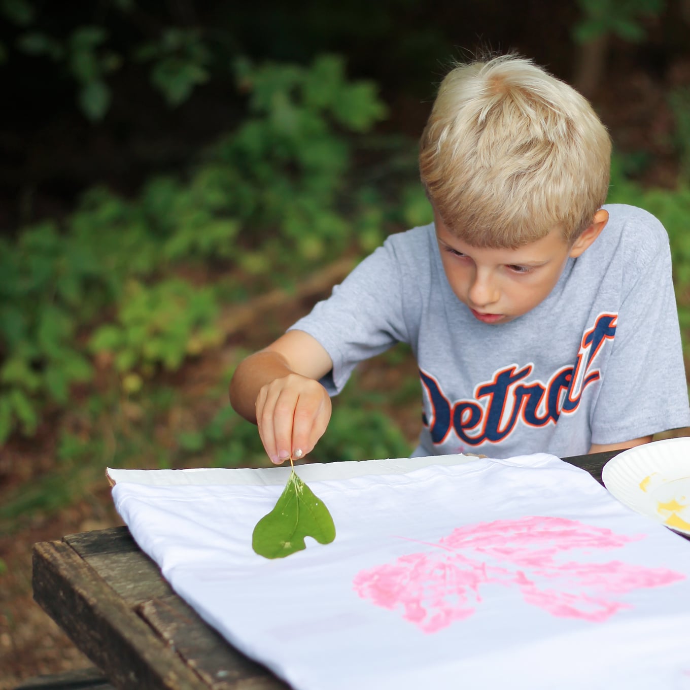 Child Stamping Leaves on T-Shirt Child Stamping Leaves on T-Shirt