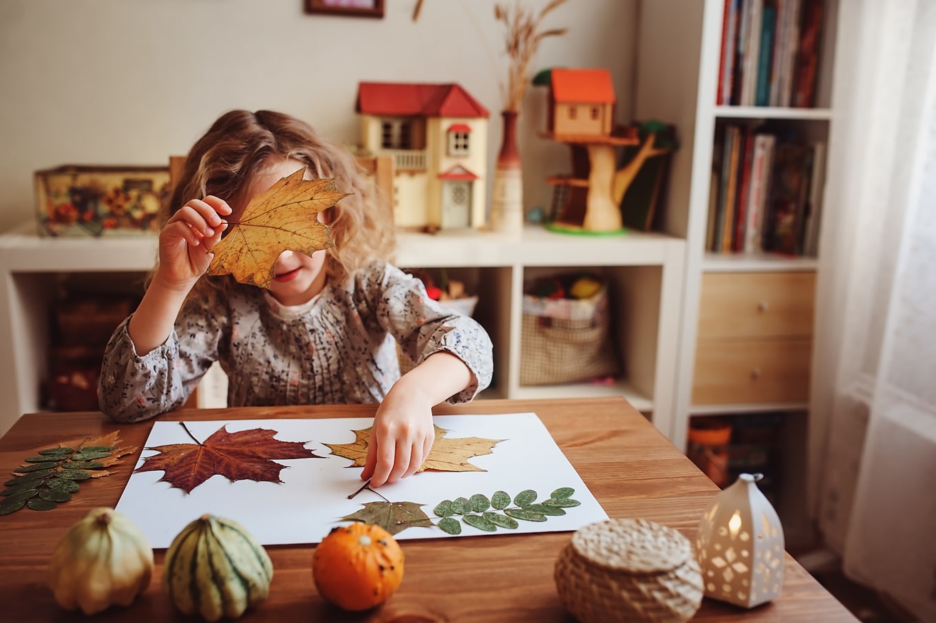 If you're on a quest to make the most of this season with your family in budget-friendly ways, here is a list of 10 Ways to Enjoy Simple Fall Family Fun! #family #parenting #fall #fallactivities #fallfun #kids Child Enjoying a Fall Nature Craft