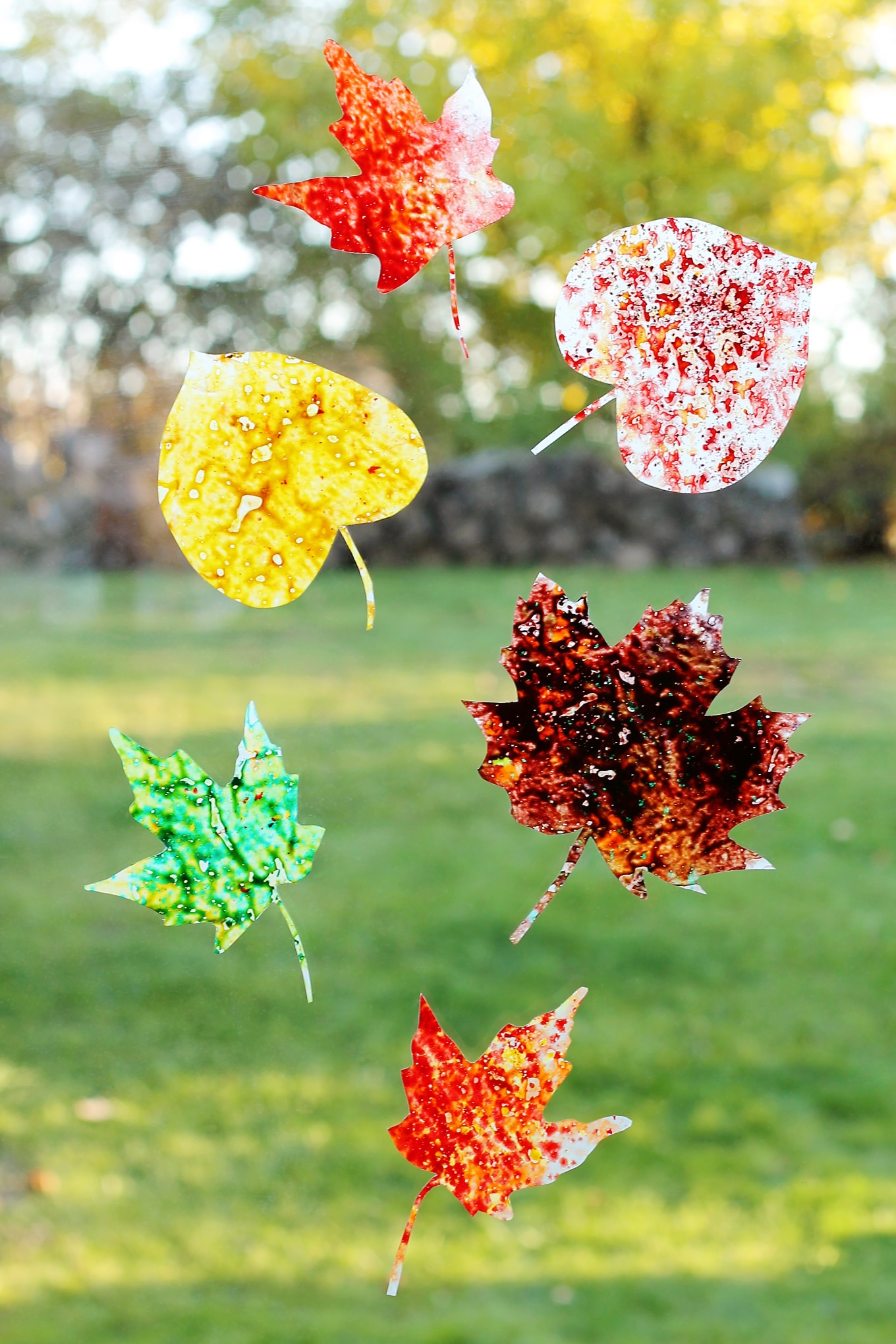 Brighten up your windows with Melted Crayon Leaf Suncatchers, a beautiful fall craft for kids!