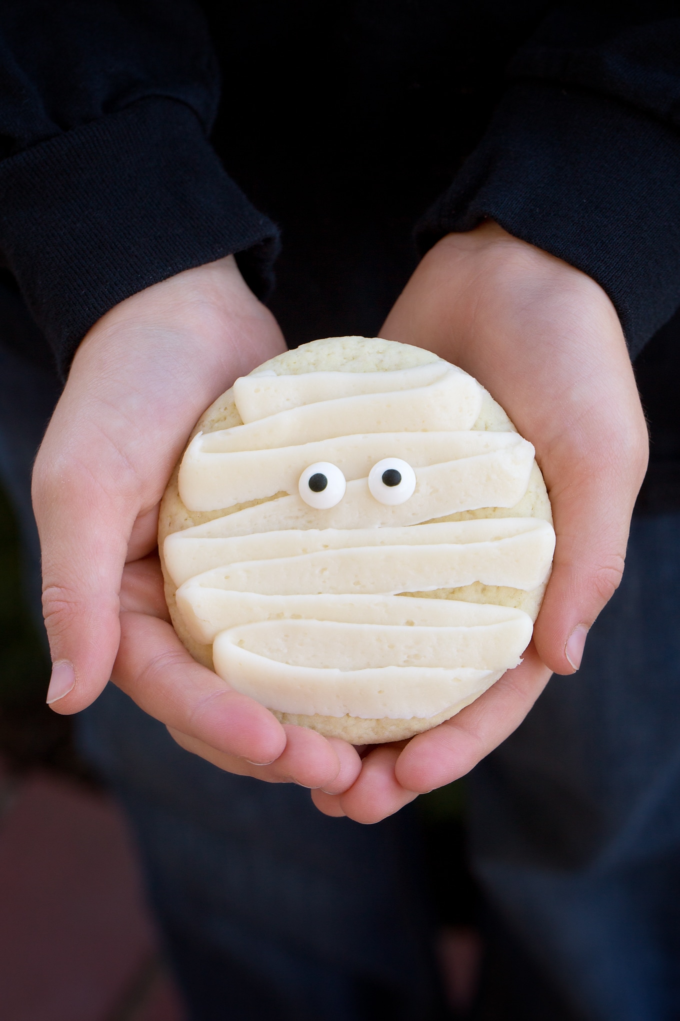 Child Holding Halloween Cookie