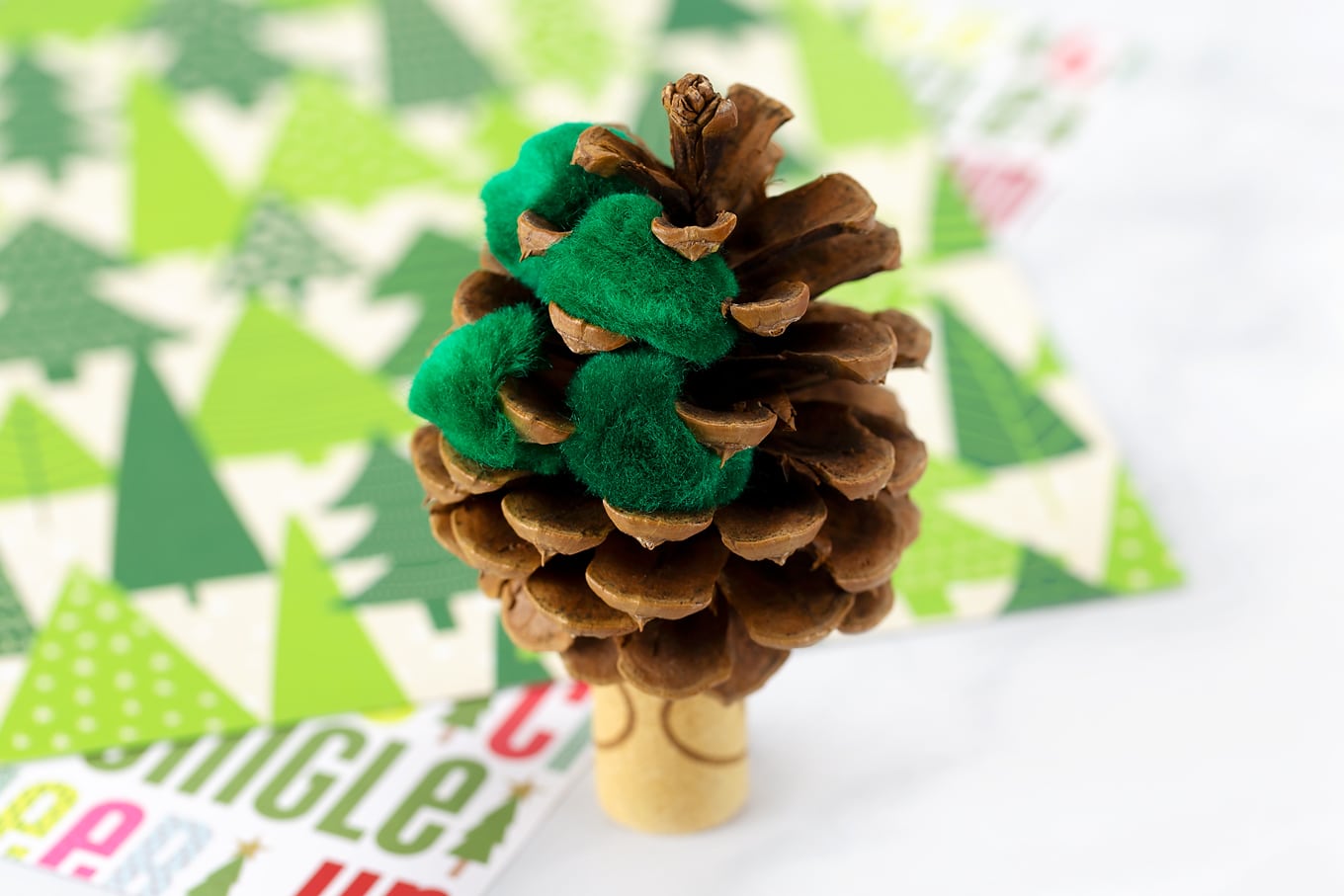 Putting Green Pompoms into the Pine Cone