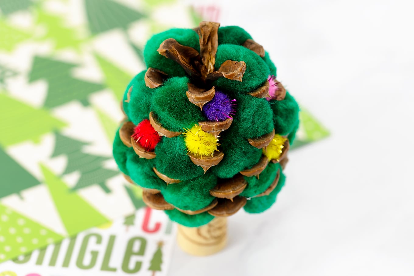 Putting Mini Pompoms into the Pine Cone