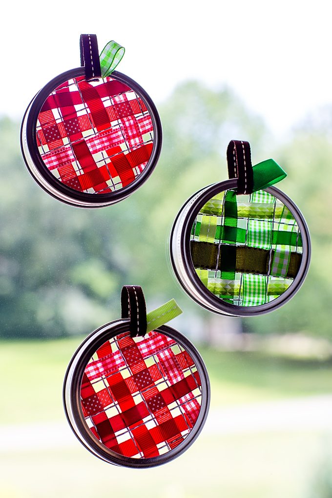 Celebrate apple season with colorful Scrap Ribbon Apple Suncatchers. They are made with mason jar frogs, rings, bits of scrap ribbon, and glue!