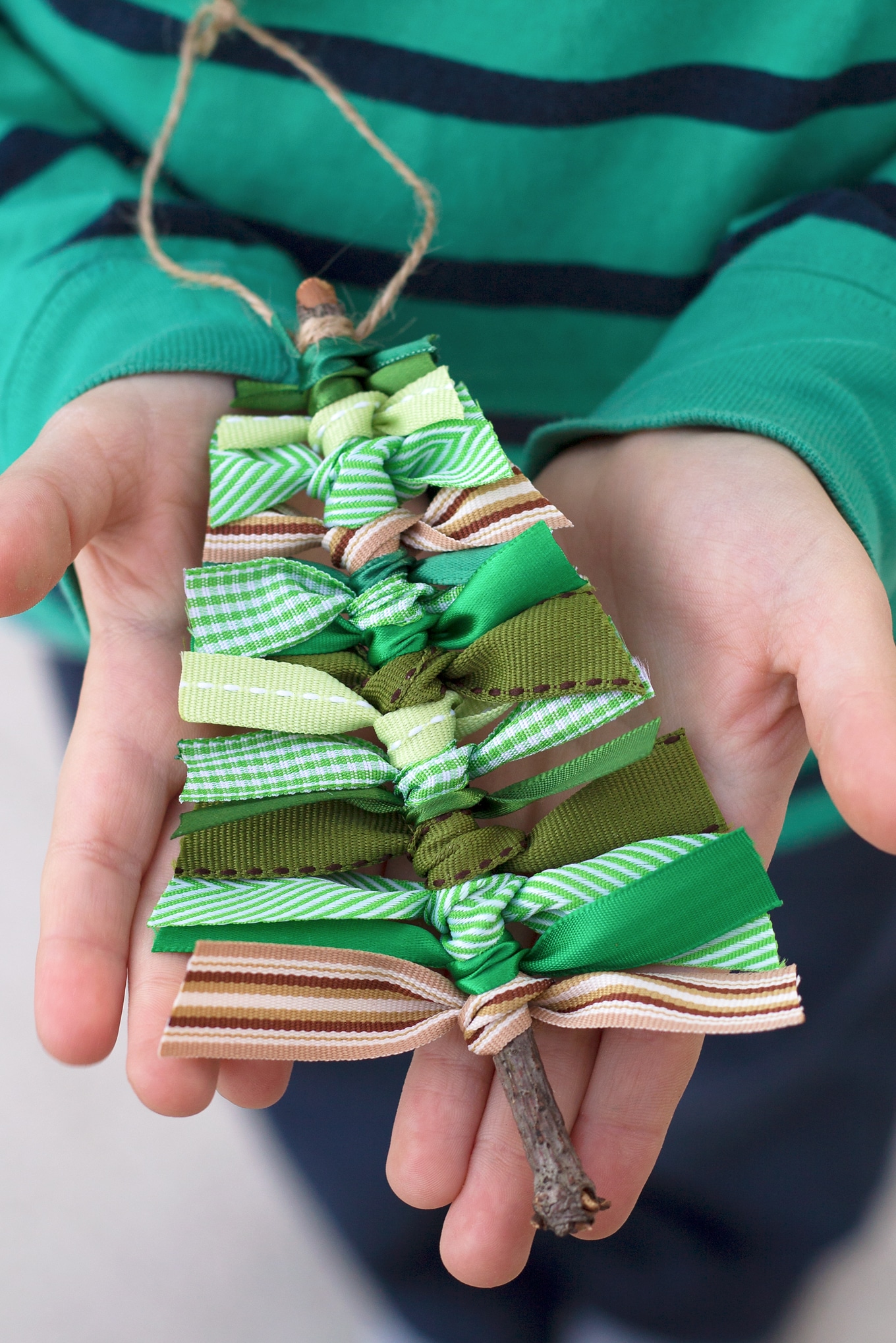 Child Holding Scrap Ribbon Christmas Tree Ornament