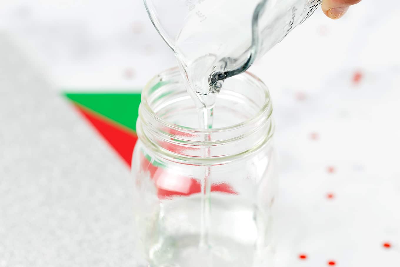 Step 2 of Glitter Jars - Pour Glue into Jar