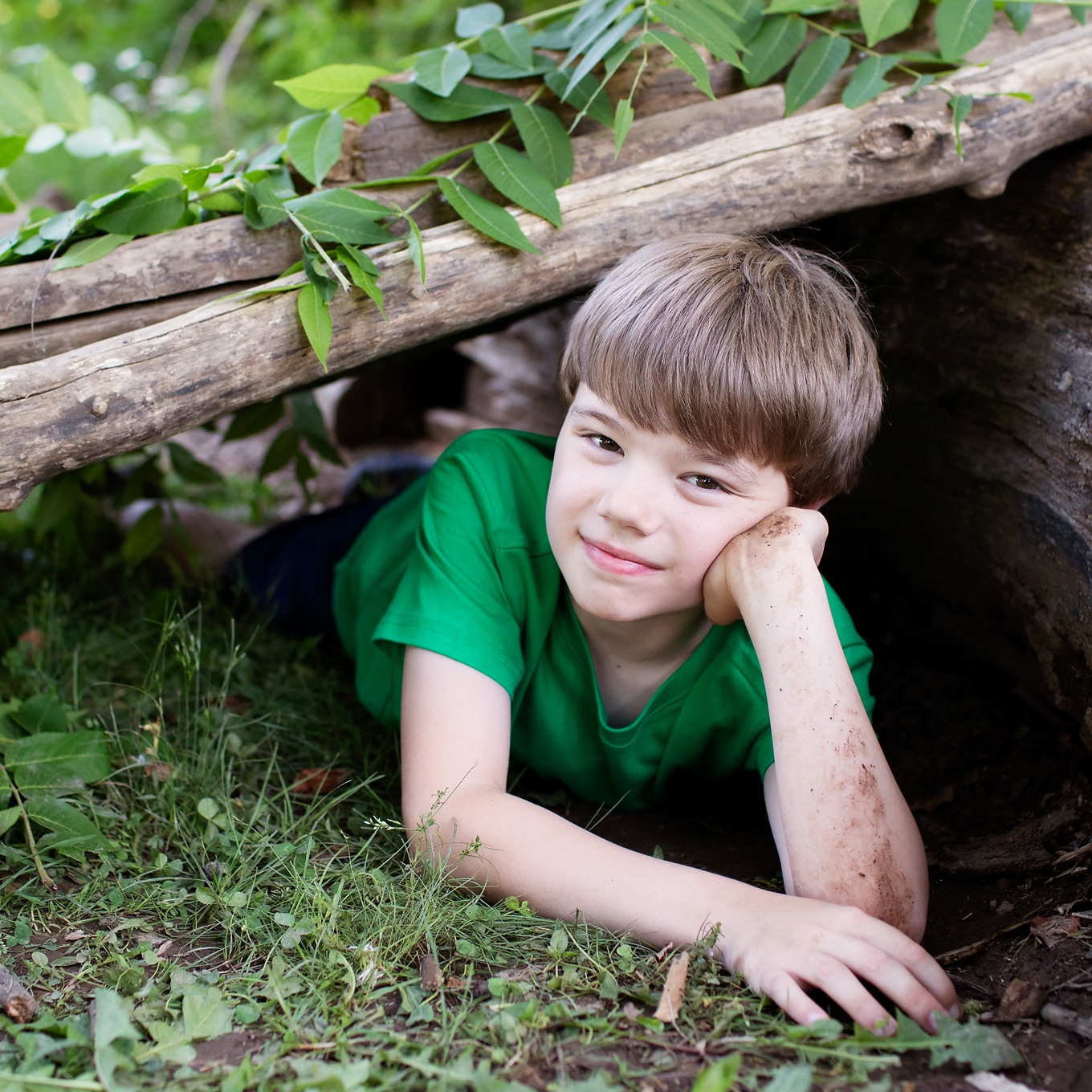Child Playing in Log Fort Child Playing in Log Fort.