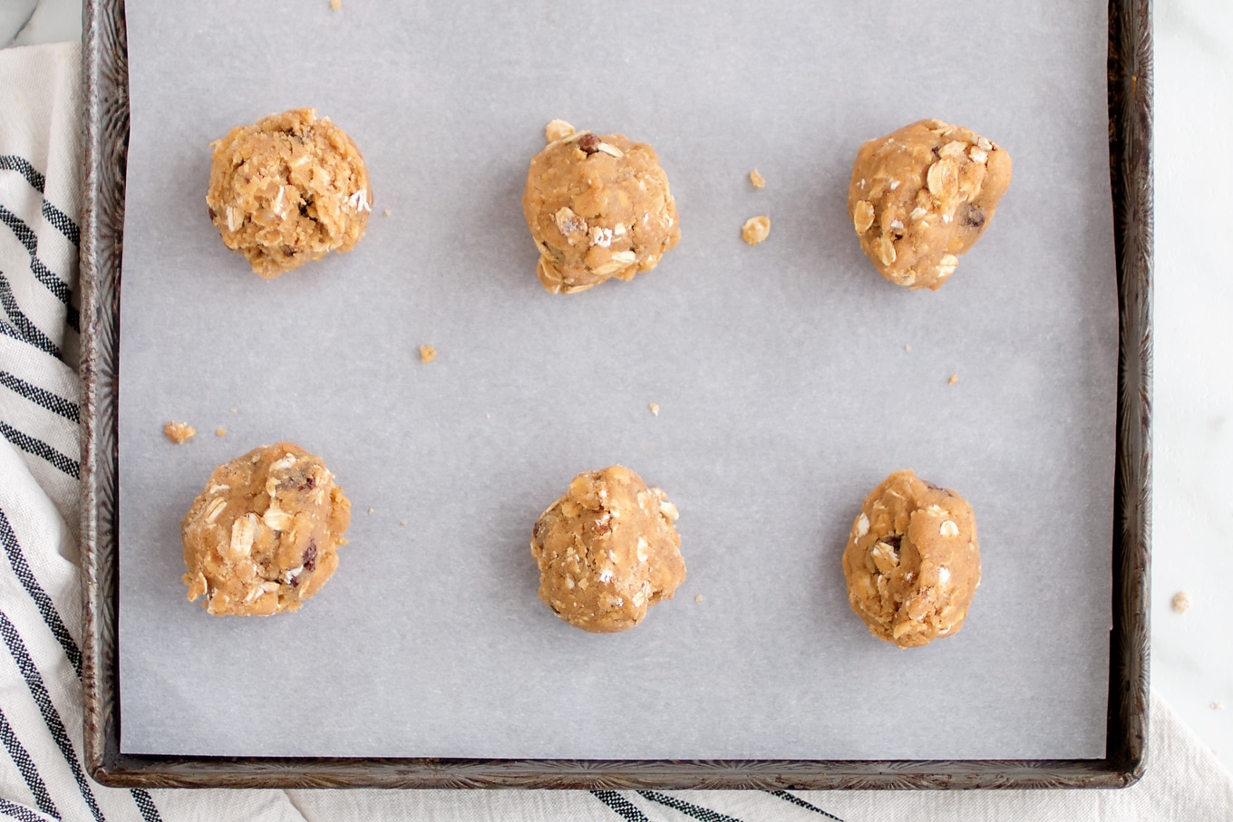 Oatmeal Raisin Cookie Dough on Parchment-Lined Pan Oatmeal Raisin Cookie Dough on Parchment-Lined Pan